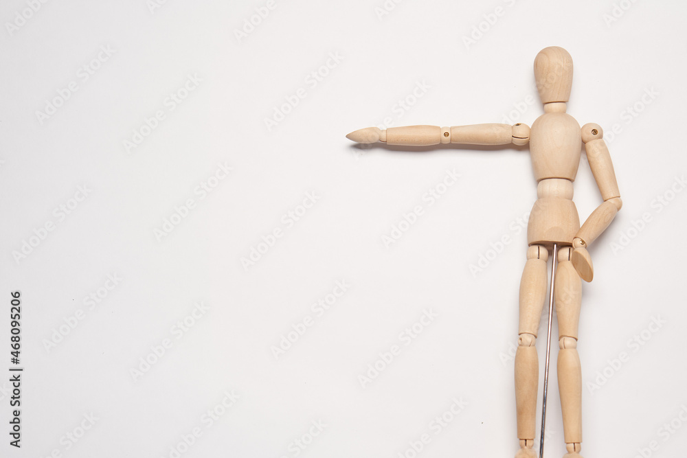 wooden mannequin posing on light background toy object