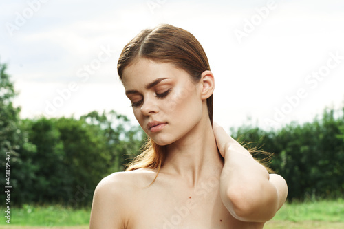 beautiful woman in a field outdoors bare shoulders clear skin model