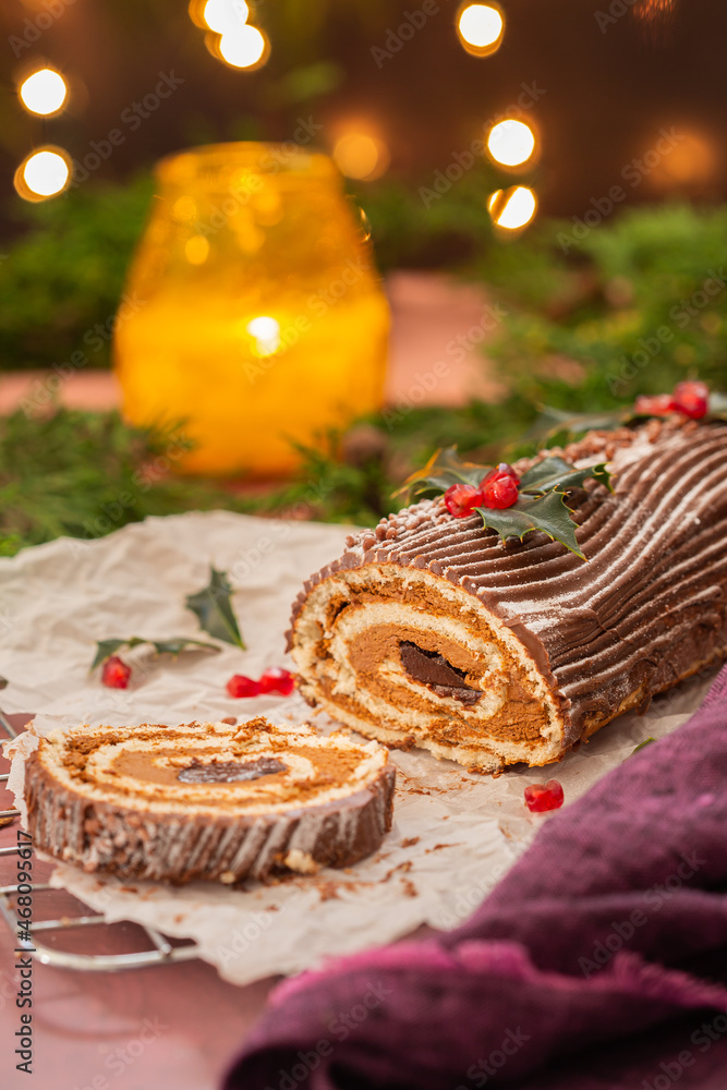 Traditional Christmas cake, chocolate Yule log with festive decorations Traditional Christmas cake, chocolate Yule log with festive decorations