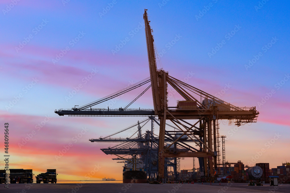 Container crane cargo freight ship with working crane loading bridge containers in shipyard at dock yard for logistic import and export transportation background.