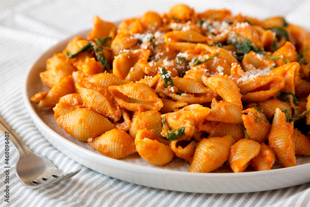 Homemade Pumpkin Pasta with Walnuts and Spinach, side view. Homemade Pumpkin Pasta with Walnuts and Spinach, side view.