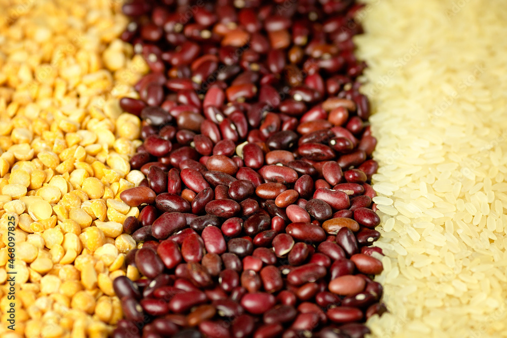 Crushed dry peas, red beans, rice background. Close-up Crushed dry peas, red beans, rice background. Close-up