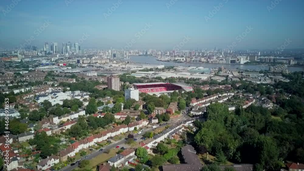 Arial Shot fast tracking of The Valley Stadium Charlton Athletic Football Club with London and themes river in the background Arial Shot fast tracking of The Valley Stadium Charlton Athletic Football Club with London and themes river in the background