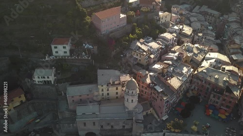 circulair and upwards tilt droneshot of an italian village at sunrise 4k. photo