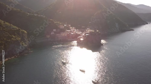 circulair droneshot at distance over sea around italian coastline at sunrise 4k.mp4 photo
