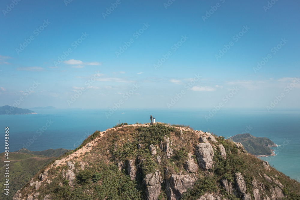 Amazing view of Man standing of Sharp Peak, Sai Kung, Hong Kong.
