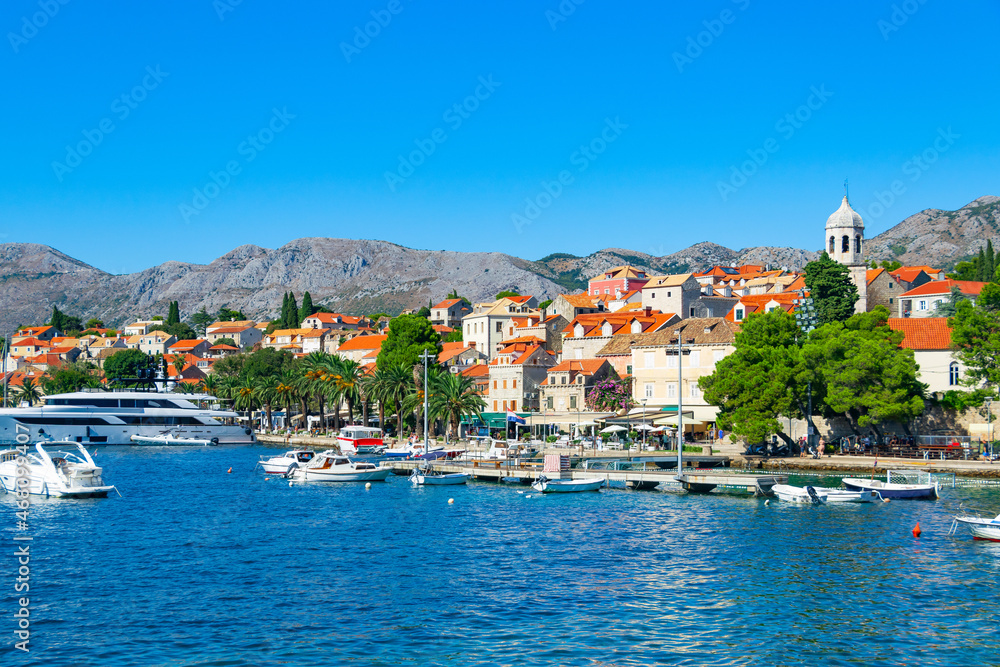 Naklejka premium A picturesque panoramic view of the ancient city of Cavtat in Croatia, surrounded by the Adriatic Sea and mountains, an embankment with moored pleasure yachts, motor boats and liners