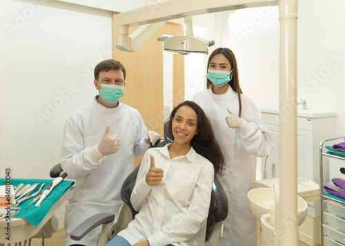 A portrait of a dentist and patient talking  smiling at hospital clinic. Teeth check up with dental tools. Doctor. Dentistry  medical and health. People.