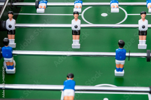 Table football in the entertainment center. Close-up image of plastic players in a football game. photo