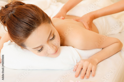 Young women relaxing in spa massage lie on your stomach on the bed