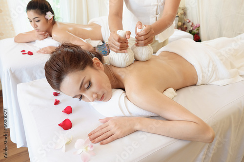 Young women relaxing in spa massage lie on your stomach on the bed