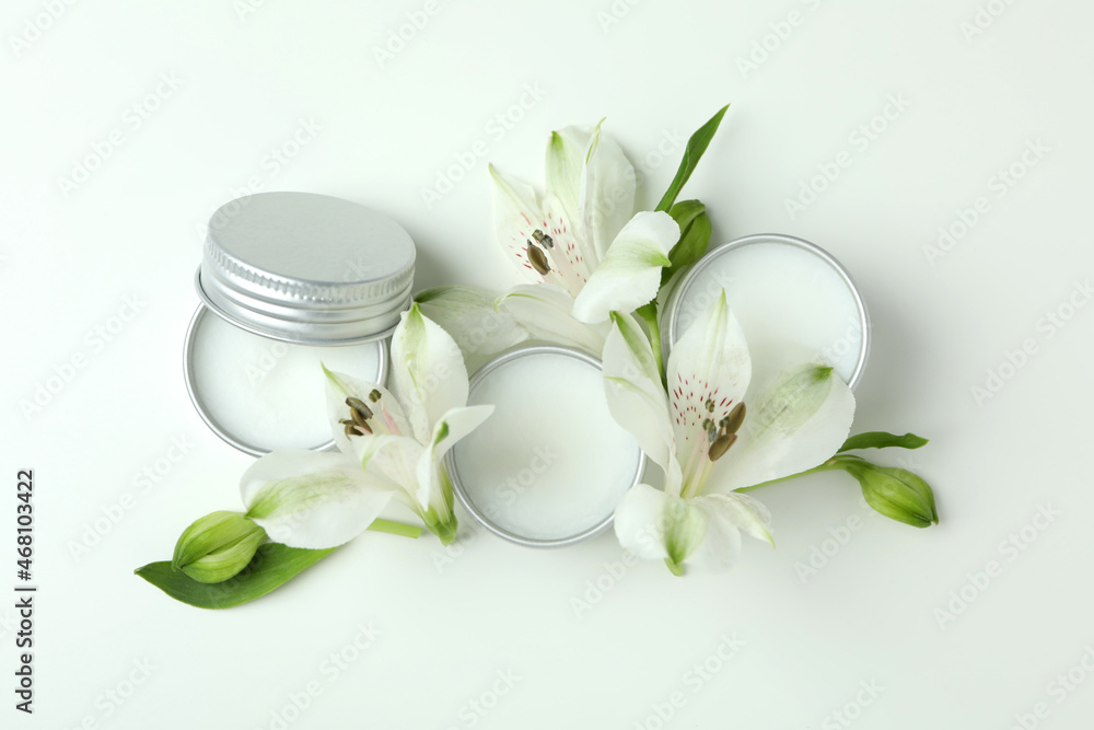 Eco lip balm and flowers on white background Eco lip balm and flowers on white background