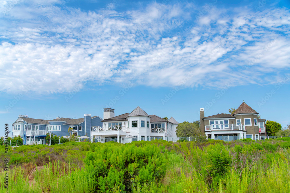 Three large houses with glass fence at Newport Beach, Orange County, California