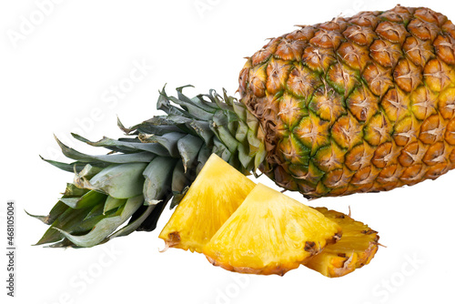 Lying fresh pineapple with slices isolated on white background.