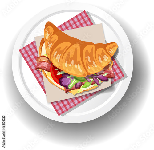 Breakfast croissant sandwich on white plate