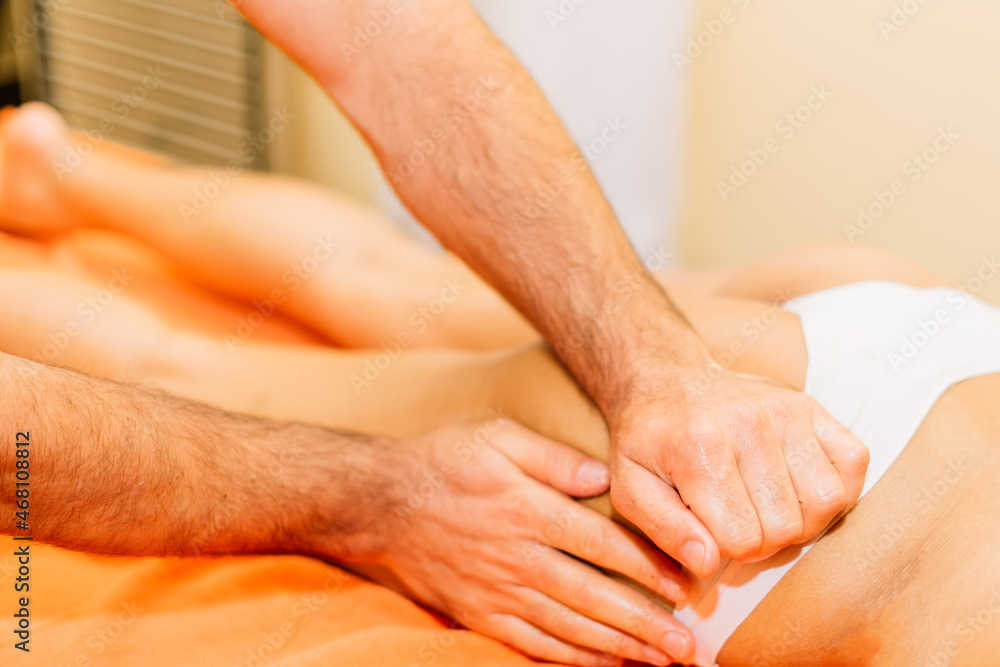 Fototapeta premium An attractive latin american woman lying down on a massage bed at a spa