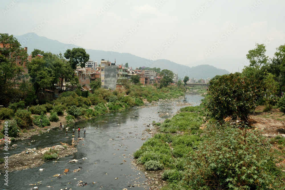 Childrens crossing river full of waste in Kathmandu 