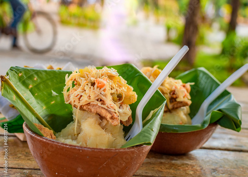 Vigorón with leaves served on a wooden table, two vigorones served on wooden background, vigorón typical food from nicaragua photo