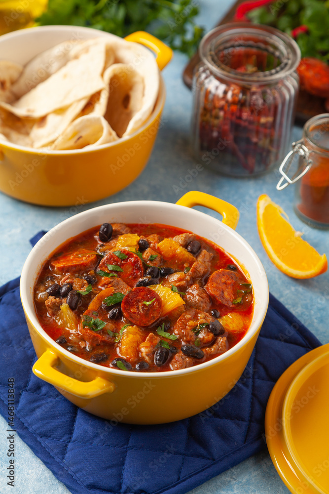Pork stew with chorizo and black beans. Served with orange and seasoned with hot chili peppers. Perfect with tortillas. Pork stew with chorizo and black beans. Served with orange and seasoned with hot chili peppers. Perfect with tortillas.