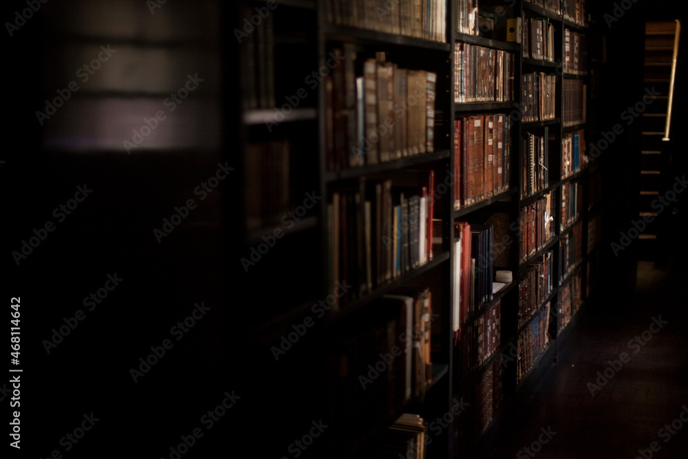 Ancient wooden library. Old books on wooden shelf High quality photo Ancient wooden library. Old books on wooden shelf High quality photo