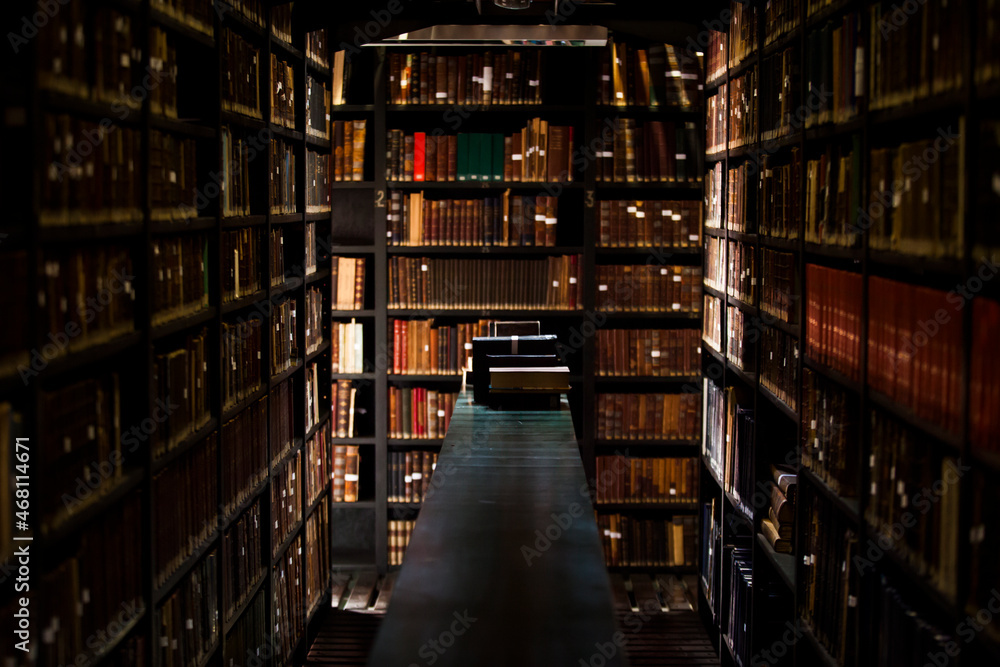 Ancient wooden library. Old books on wooden shelf High quality photo Ancient wooden library. Old books on wooden shelf High quality photo