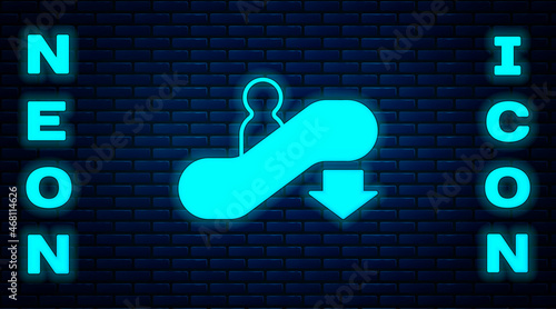 Glowing neon Escalator down icon isolated on brick wall background. Vector