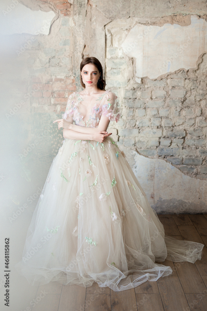 A tender bride in a light fashion dress in a loft cafe A tender bride in a light fashion dress in a loft cafe