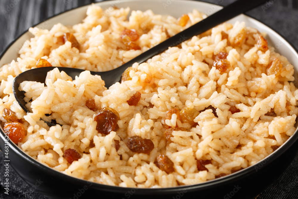 Coconut Rice With Raisins Arroz con Coco close up in the bowl on the table. Horizontal Coconut Rice With Raisins Arroz con Coco close up in the bowl on the table. Horizontal