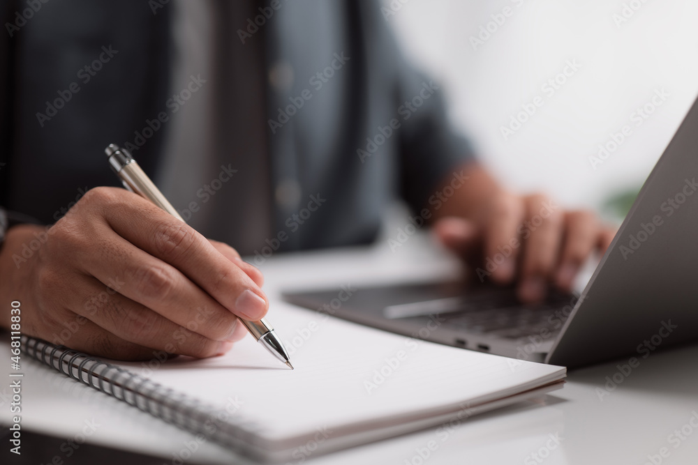 Businessman working at his desk with his laptop and documents in office. Businessman working at his desk with his laptop and documents in office.