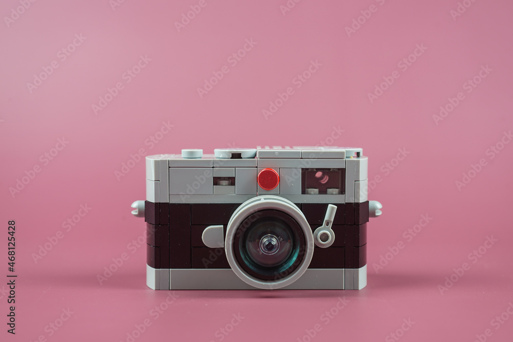 small plastic camera on pink background