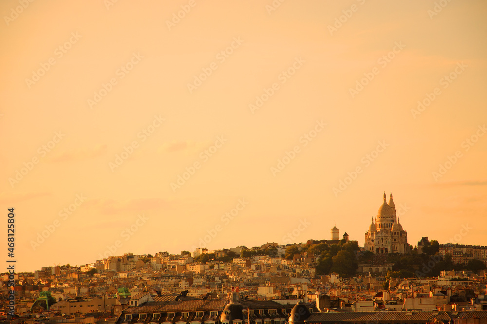 Parisian cityscape at sunset with a view of  Sacre Coeur Basilica.