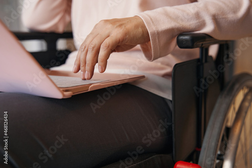 Woman with paraleria using notebook at home