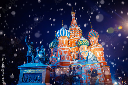 Winter night light Moscow Red square with snow. Christmas Russia holidays St Basils Cathedral new year background bokeh
