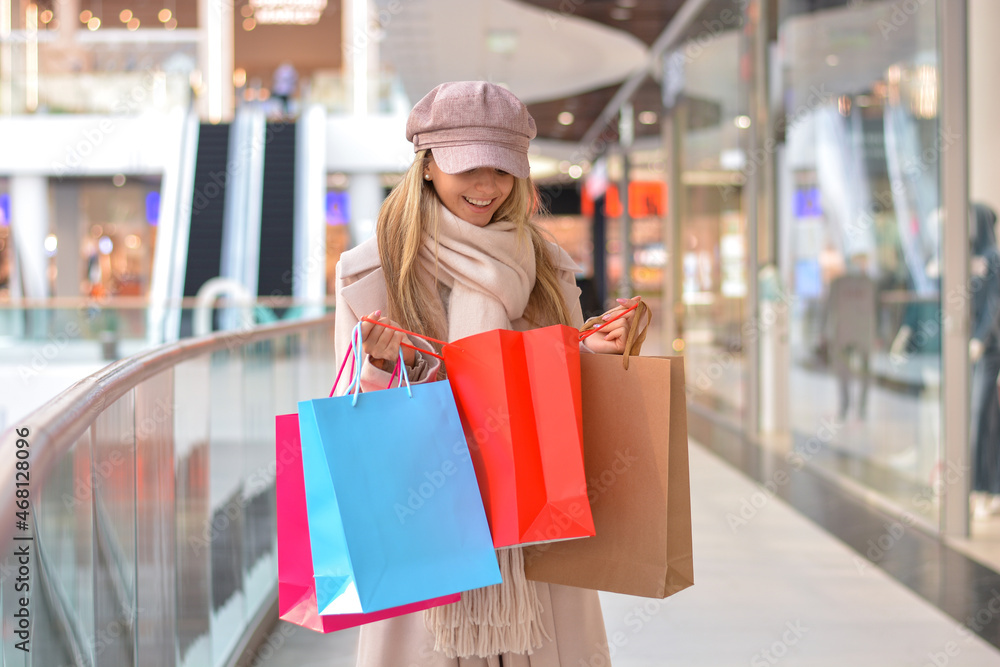 Happy girl with shopping bags in the Shopping Mall.Shopper. Sales. Shopping Center.Cyber Monday.Black Friday