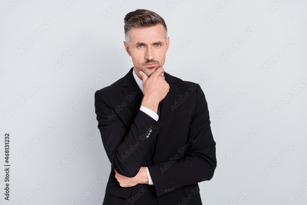 Photo of confident attentive young specialist wear black jacket arm chin listening you isolated grey color background Photo of confident attentive young specialist wear black jacket arm chin listening you isolated grey color background