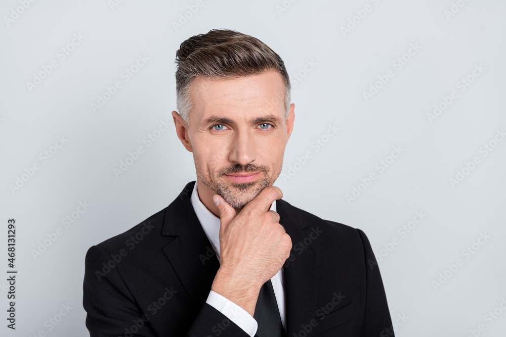 Photo of attentive serious young recruiter wear black jacket arm chin looking you isolated grey color background Photo of attentive serious young recruiter wear black jacket arm chin looking you isolated grey color background