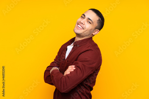 Asian handsome man isolated on yellow background with headache