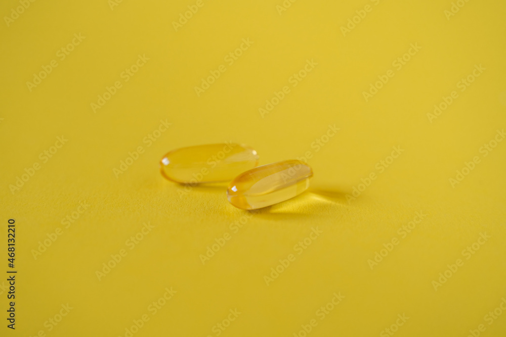 Omega 3 capsules on yellow background. Healthy lifestyle. Food supplements Omega 3 capsules on yellow background. Healthy lifestyle. Food supplements