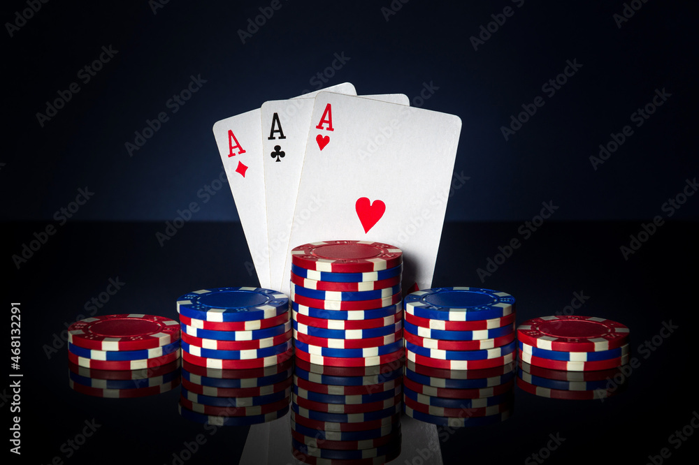Obraz premium Poker game with three of kind or set combination. Chips and cards on table. Successful and win three aces