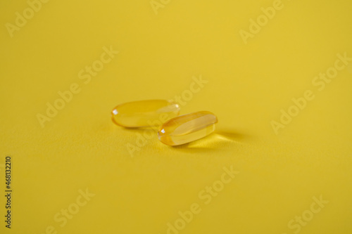 Omega 3 capsules on yellow background. Healthy lifestyle. Food supplements