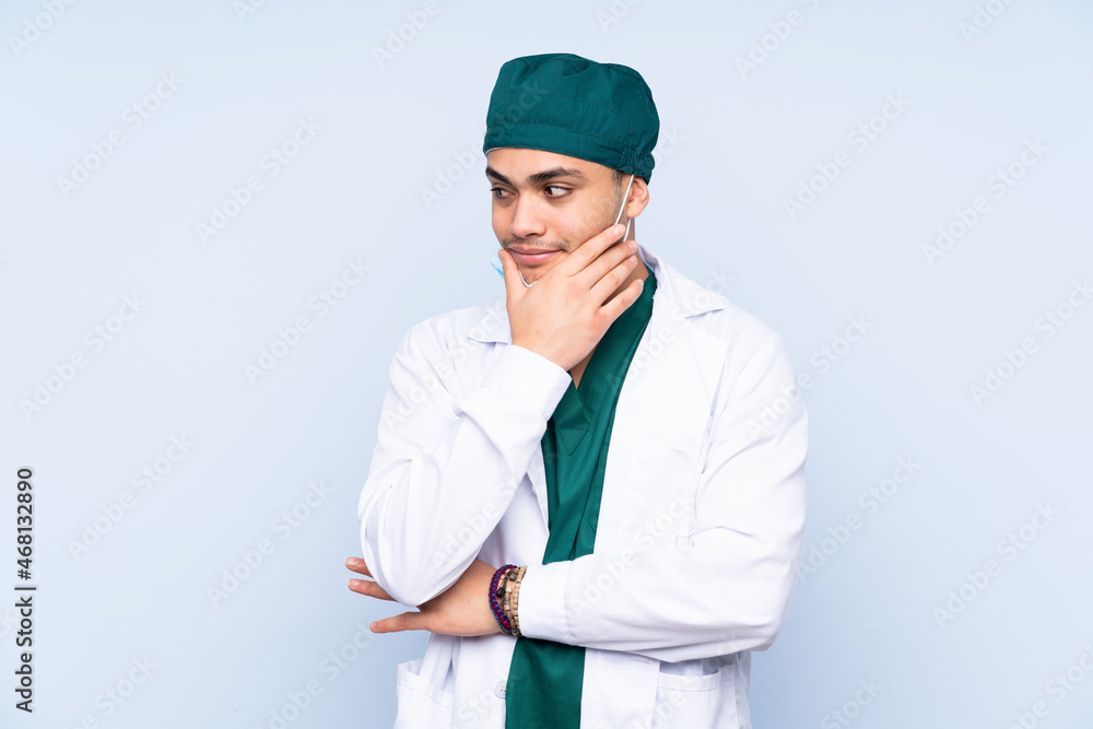 Surgeon man with uniform isolated on blue background thinking an idea Surgeon man with uniform isolated on blue background thinking an idea