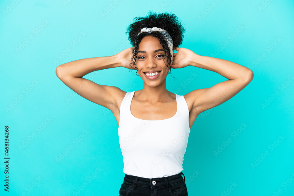 Young latin woman isolated on blue background laughing