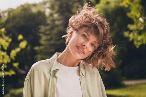 Portrait of attractive dreamy confident cheerful girl pastime free time good mood enjoying staying on fresh air outdoors photo