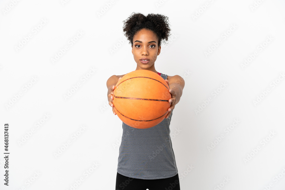 Young basketball player latin woman isolated on white background playing basketball Young basketball player latin woman isolated on white background playing basketball