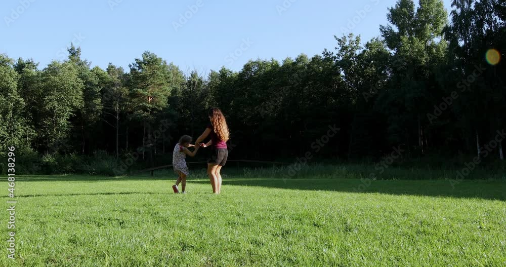 Happy family are played with children in the park at sunset. Happy family are played with children in the park at sunset.