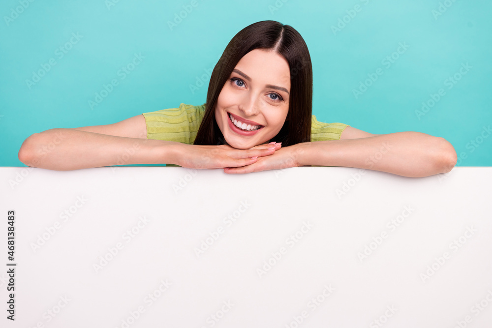 Photo of adorable positive cute lady enjoy empty space white wall wear green blouse isolated teal color background Photo of adorable positive cute lady enjoy empty space white wall wear green blouse isolated teal color background