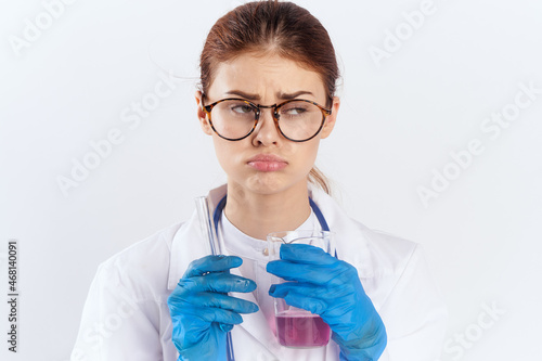 female doctor sitting at the table with blue gloves medication tests