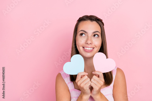 Photo of young dreamy woman curious imagination small paper heart romantic isolated over pastel color background