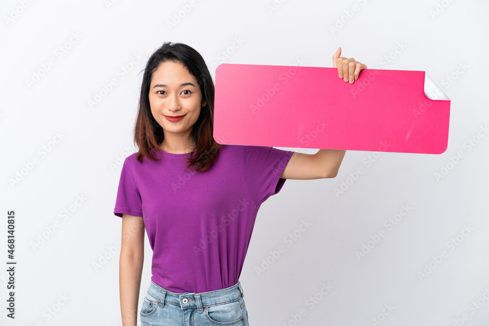 Young Vietnamese woman isolated on white background holding an empty placard Young Vietnamese woman isolated on white background holding an empty placard