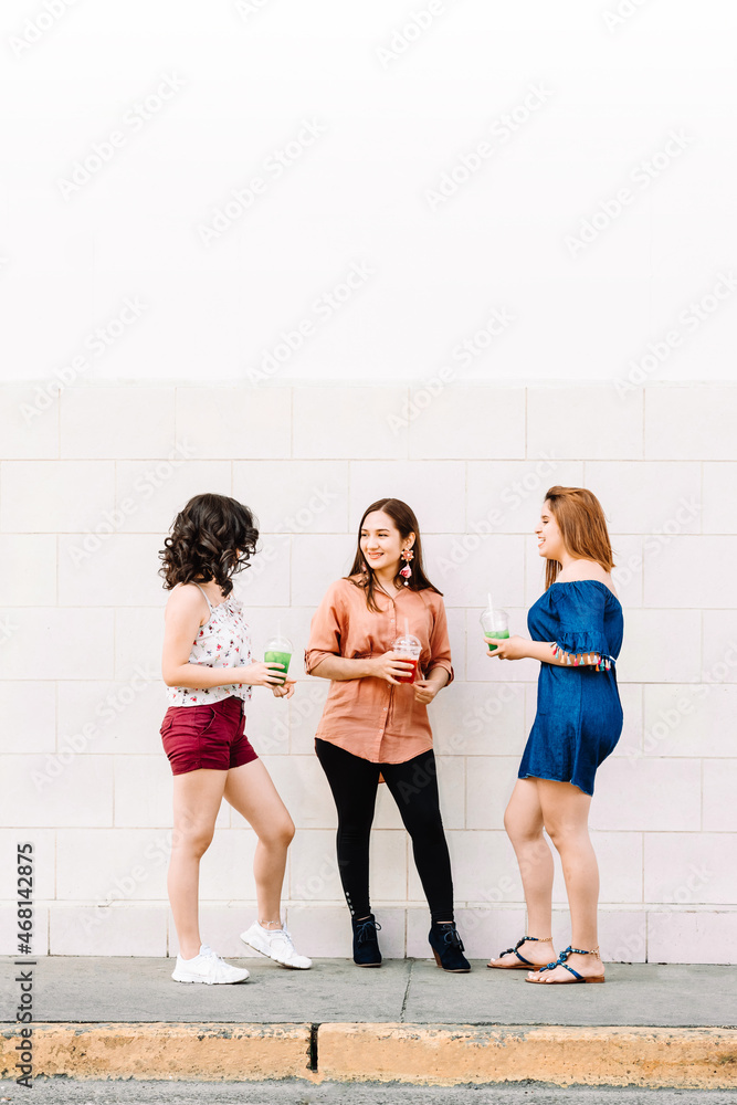 Naklejka premium Group of hispanic women talking on the street city.